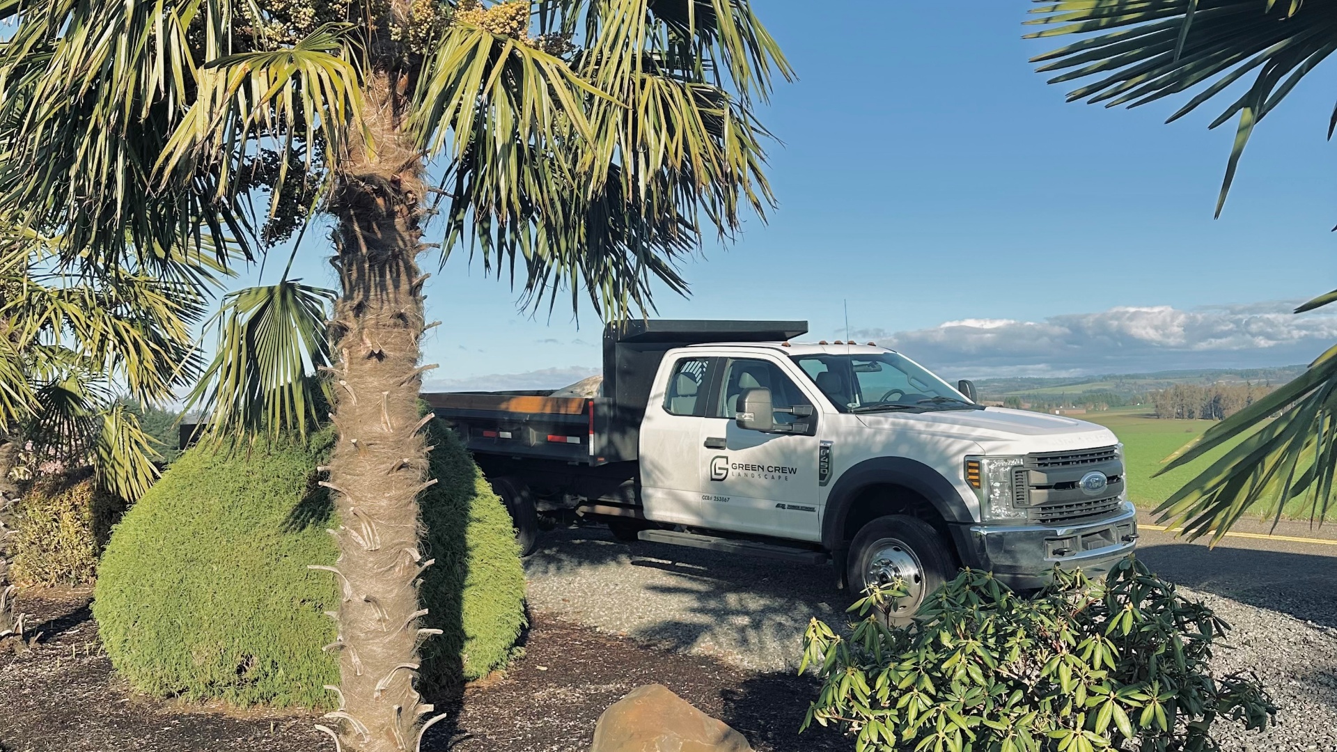 Green Crew Landscape truck and trailer